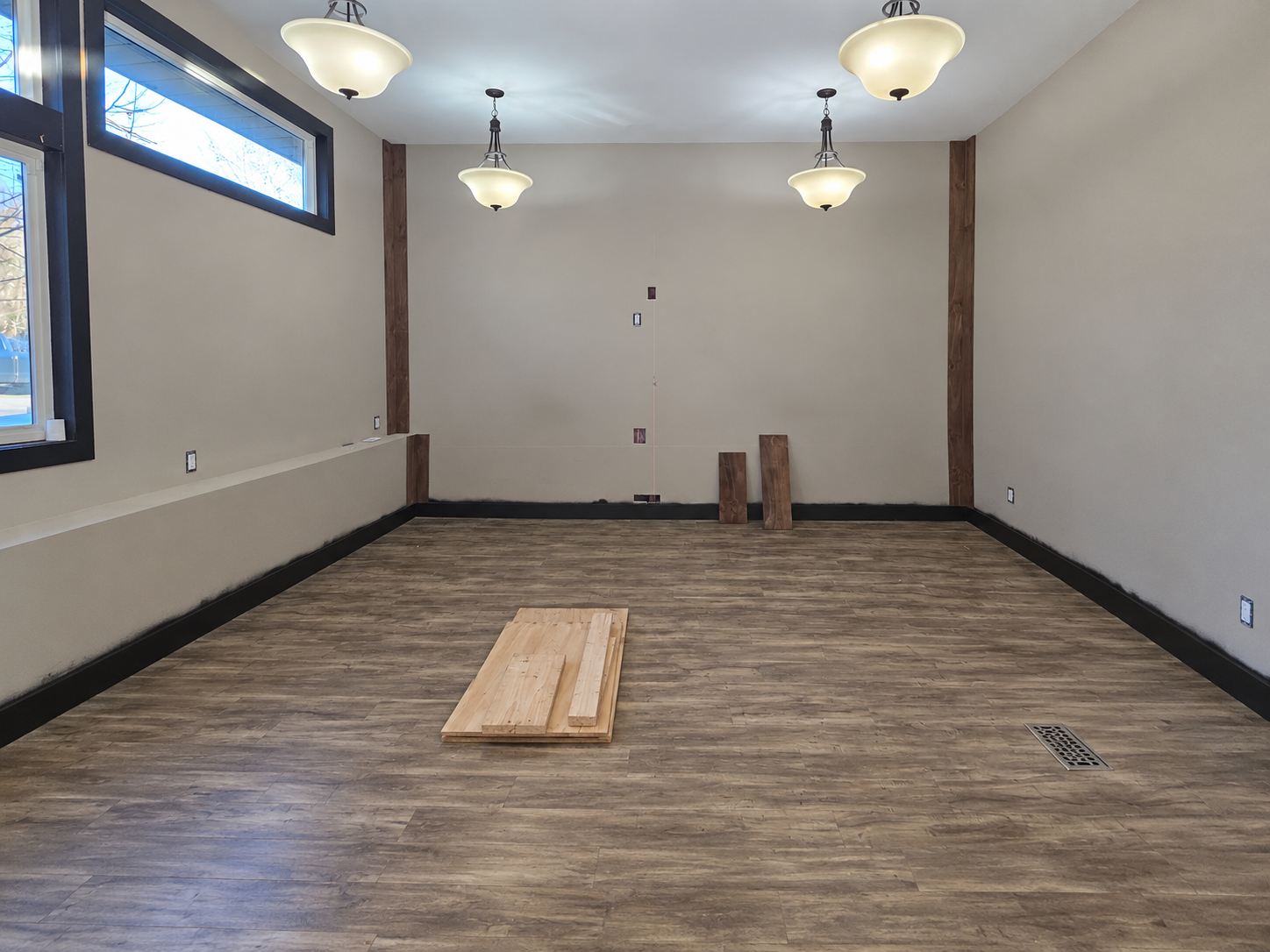 Lounge before renovation with unfinished walls and flooring